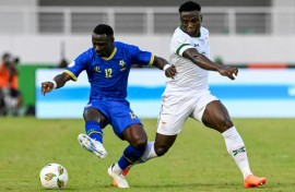 Simon Msuva (L) of Tanzania shields the ball from Lameck Banda of Zambia.
