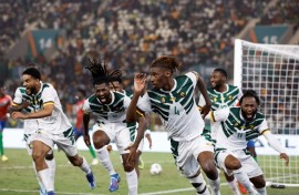 Christopher Wooh (3R) celebrates after scoring the winning goal for Cameroon against Gambia.
