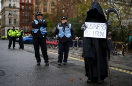 Watched by police, British environment activists take part in a London demonstration