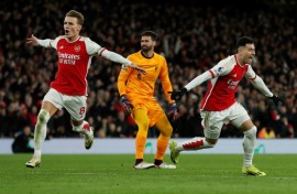 Arsenal's Gabriel Martinelli  (R) celebrates scoring after a mistake from Liverpool keeper Alisson Becker