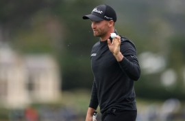 Wyndham Clark of the United States acknowledges the crowd after making the course record low score of 60 at the Pebble Beach Pro-Am on Saturday.