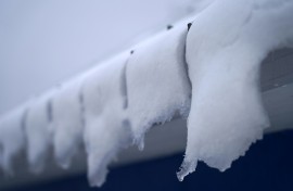 Snow melts on the roof of an ice fishing cabin in Sainte-Anne-de-la-Perade, Quebec, Canada in January 2024