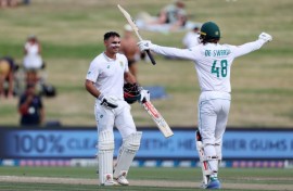 South Africa's David Bedingham (left) is congratulated after reaching his hundred by Ruan de Swardt