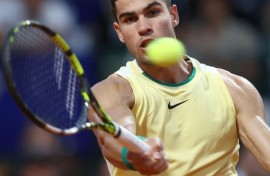 Moving on: Carlos Alcaraz returns the ball to Andrea Vavassori 