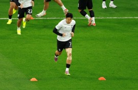 Captain Son Heung-min, his fingers bandaged, warms up ahead of South Korea's semifinal loss to Jordan at the Asian Cup