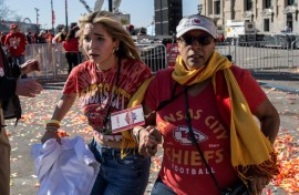 People flee after shots were fired near the Kansas City Chiefs' Super Bowl LVIII victory parade on February 14, 2024, in Kansas City, Missouri