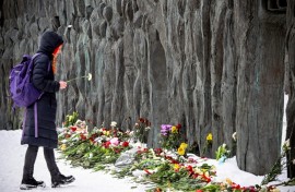 Some mourners gathered at a monument to victims of Soviet-era repression known as the 'Wall of Grief'