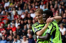 Arsenal's Martin Odegaard (L) and Bukayo Saka are dreaming of Champions League and Premier League glory