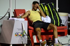 Spain's Carlos Alcaraz gestures after suffering an ankle injury in his ATP Rio Open first-round match against Thiago Monteiro