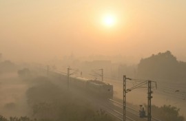 A train passes through heavy smog in India, where authorities have ordered an investigation into a runaway train incident