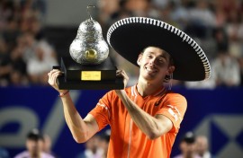 Australia's Alex de Minaur celebrates with his trophy after winning the ATP Mexico Open final over Norway's Casper Ruud