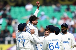 India's Kuldeep Yadav (2L) celebrates after taking five-wicket haul during the first day of the fifth Test