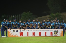 Sri Lanka's cricketers pose with the Twenty20 trophy after winning the three-match series against Bangladesh 2-1 -- pointing to their watches in an apparent reference to  the "timed out" controversy of last year's World Cup 