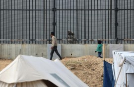 Displaced Gazans in the Rafah camps can see Egyptian soldiers on patrol just across the border fence