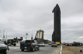People gather as SpaceX Starship spacecraft prototype is transported from the launch site ahead of the SpaceX Starship third flight test from Starbase in Boca Chica, Texas 