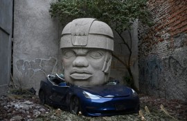 This Tesla 3 car crushed by a nine-ton Olmec-inspired head is the doing of Mexican artist Chavis Marmol