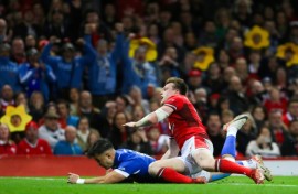 Excellent score: Italy full-back Lorenzo Pani (under L) dives across the line to score a try in a xx-x Six Nations win over Wales in Cardiff