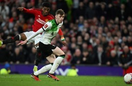 Manchester United substitute Amad Diallo (L) scores the winning goal against Liverpool in an FA Cup quarter-final.
