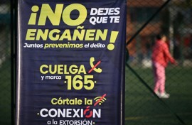 A poster in a crime-hit neighborhood of Bogota, urging people to report extortion attempts 