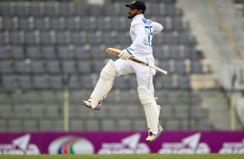 Sri Lanka's Dhananjaya de Silva celebrates after scoring a century during the third day of the first Test cricket match between Bangladesh and Sri Lanka