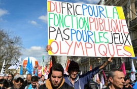 A protester holds a banner reading 'Cash for civil services, not for the Olympic Games' during a demonstration last week