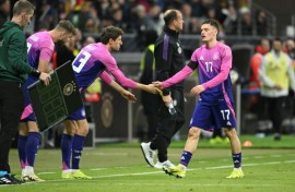 Germany midfielder Florian Wirtz shakes hands with Thomas Mueller in Tuesday's 2-1 win over the Netherlands in Frankfurt