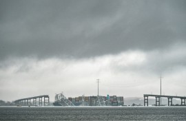 The Dali, a Singaporean-flagged cargo vessel that spans the size of almost three football fields, remains stuck under debris from the Francis Scott Key Bridge on March 27, 2024 after the ship crashed into the bridge in Baltimore, Maryland