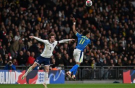 England defender Ben Chilwell (L) in action against Brazil midfielder Raphinha (R) during a recent friendly international at Wembley
