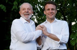 Brazilian President Luiz Inacio Lula Da Silva (L) and French President Emmanuel Macron smile together at Combu Island, Brazil, on March 26, 2024