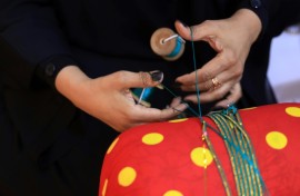The art of hand-weaving braided shiny ribbons to adorn traditional clothing and bags is called Al Talli, and is on UNESCO's Intangible Cultural Heritage of Humanity list