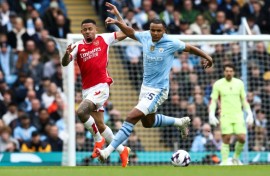 Yellow card complaint: Manchester City defender Manuel Akanji (R) in action against Arsenal's Gabriel Jesus (L) 