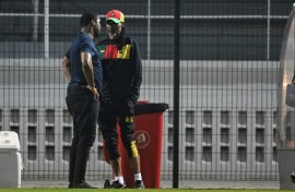 Cameroon football federation president Samuel Eto'o (L) talks to former coach Rigobert Song during an AFCON training session