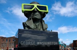 Eclipse glasses are worn by a statue of George Washington on April 07, 2024, in Houlton, Maine