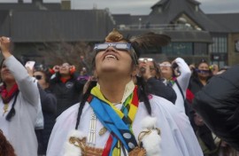 Despite cloudy skies, thousands of people flock to Niagara Falls in Canada to witness a rare total solar eclipse