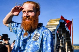 British runner Russ Cook posing at the sculpture marking the northern-most point of Africa after running the full length of the continent
