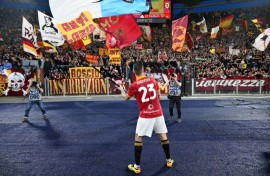 Gianluca Mancini waves a flag depicting a rat in front of Lazio colours after Saturday's Rome derby