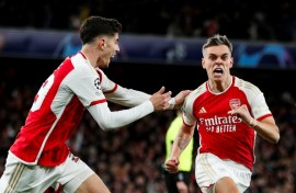 Arsenal's Leandro Trossard (R) celebrates after scoring against Bayern Munich