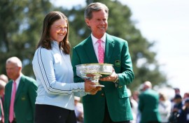 Augusta National chairman Fred Ridley presents Lottie Woad of England with the trophy following the final round of the Augusta National Women's Amateur at Augusta National Golf Club.