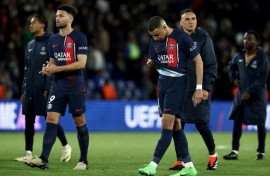 Kylian Mbappe walks off the pitch with PSG teammates after the French side's 3-2 defeat by Barcelona in the first leg of their Champions League quarter-final tie