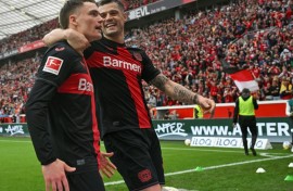 Florian Wirtz (L) and Granit Xhaka (R) will be staying with new Bundesliga champions Bayer Leverkusen next season
