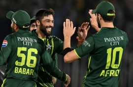 Back in business: Mohammad Amir (2L) celebrates after taking the wicket of New Zealand's Dean Foxcroft 