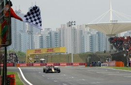 Red Bull Racing's Dutch driver Max Verstappen takes the chequered flag in Shanghai