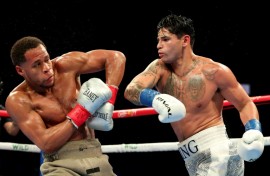 Ryan Garcia (white trunks) punches Devin Haney (gray trunks) on the way to a majority decision victory in their super-lightweight bout in Brooklyn, New York