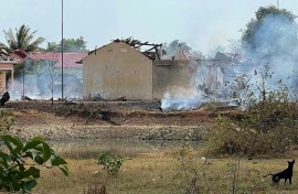Smoke billows from a warehouse following an explosion at an army base in Cambodia