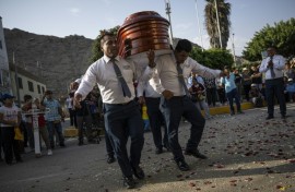 Peru's 'dancer's of death' show off intricate footwork as they bear a coffin to its final resting place 