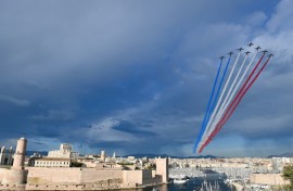 The French Air Force display team  sprays the colours of the French flag above Marseille's Old Port as the Olympic flame arrives