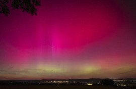 Northern Lights, or aurora borealis, illuminate the night sky near London, Ontario, during the most powerful solar storm in more than two decades