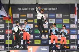 Sebastien Ogier (C) celebrates a record sixth Rally of Portugal victory