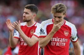 Arsenal's Martin Odegaard (R) and Jorginho (L) react after their title disappointment
