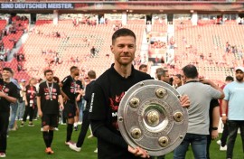 'Outstanding': Bayer Leverkusen coach Xabi Alonso poses with the Bundesliga trophy 